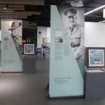 Series of banners in light teal and showing black and white photos.